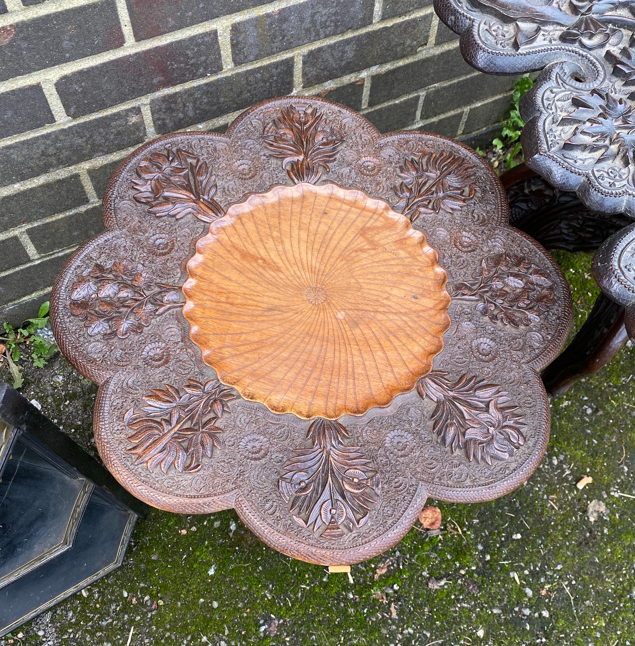 Two Indian carved hardwood occasional tables, a Victorian ebonised corner wall bracket and an industrial stool